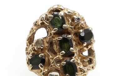 A garnet-and diamond ring set with five faceted presumably green garnets, two...