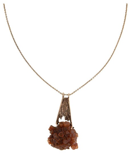 A gold and Aragonite pendant, mounted in a textured gold pendant mount to a curb link chain, length 62cm, pendant 3.5cm x 6cm, Edinburgh hallmarks for 9-carat gold. c.1975 Accompanied by original receipt dated 17.9.76