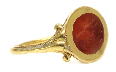A gold cornelian intaglio ouroboros ring