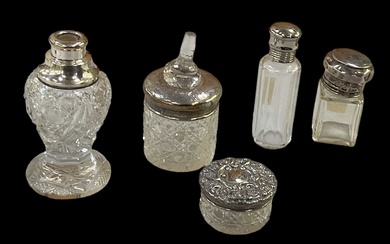 A group of four hallmarked silver topped scent bottles, one...