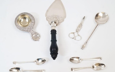 A group of silver and oddments comprising: a silver tea strainer with Chester import marks; a pair of silver sugar nips, marks rubbed; a silver spoon with figural terminal; four Georgian silver teaspoons, three with rubbed picture backs; a silver...