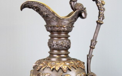 A large 19th Century bronze urn decorated with putti, H. 57cm.