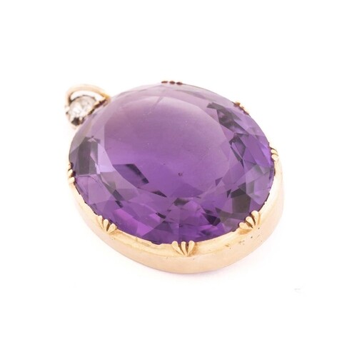 A large amethyst and diamond pendant, featuring an oval mixe...