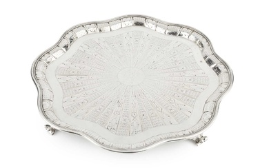 A late Victorian silver salver, of wavy outline, having reeded...