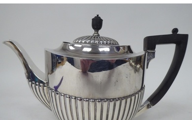 A late Victorian silver teapot of oval, demi-reeded form wit...