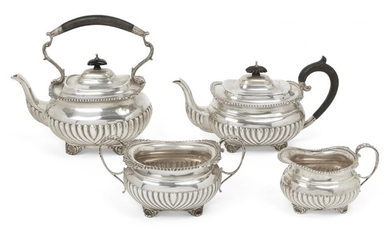 A matched silver four-piece tea service, the teapot and tea...