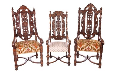 A near pair of Victorian carved oak open armchairs, in the Carolean style, with open S-Scroll