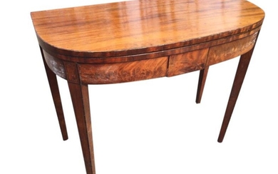 A nineteenth century D-shaped mahogany turn-over-top tea table, the...