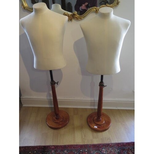 A pair of 20th century calico covered tailors busts on turne...