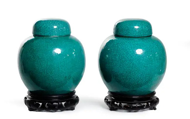 A pair of Chinese monochrome apple green glazed jars and covers, Late...
