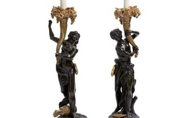 A pair of French bronze lamps after Clodion