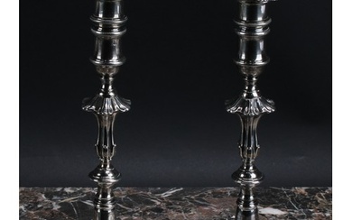 A pair of George II cast silver table candlesticks, unusuall...