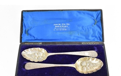 A pair of George III cased silver berry spoons by George Smi...