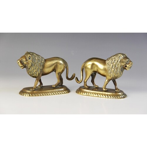 A pair of Indian brass models of lions, late 19th/early 20th...
