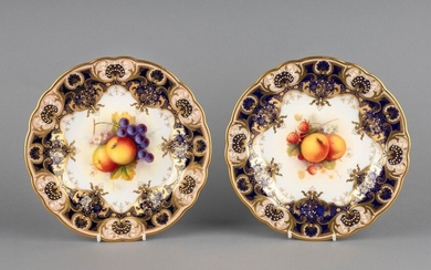 A pair of Royal Worcester dessert plates painted with fruit and signed by A. Shuck, 9 in. (22.9 cm.) d.
