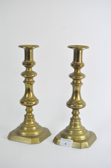 A pair of late 19th century brass candlesticks