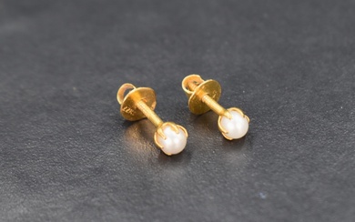 A pair of pearl stud earrings, the white pearls set in twenty-two carat gold with screw posts and