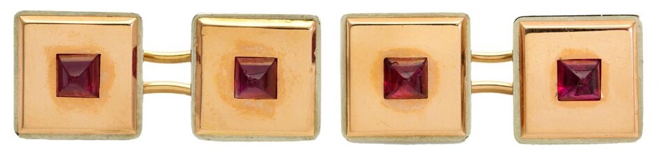 A pair of ruby cufflinks, by Cartier, each square link of two colour gold centring on a single buff top ruby to baton connecting links, signed Cartier and numbered 04357 and 04209 French marks, c.1930