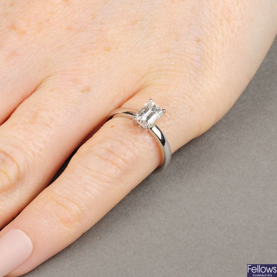 A platinum rectangular-shape diamond single-stone ring.