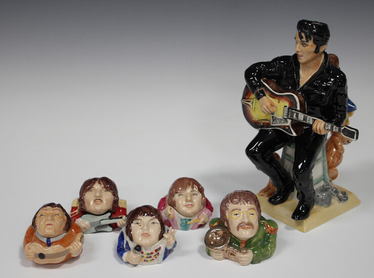 A prototype Kevin Francis model of Elvis Presley, modelled seated playing his guitar, painted in puc