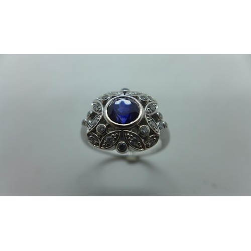 A very pretty 18ct white gold diamond and sapphire ring, the...