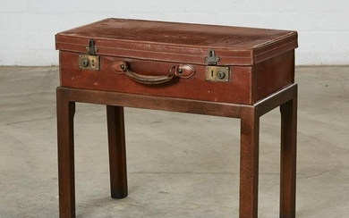 A vintage leather suitcase on stand