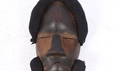 African Dan tribal wood carved mask with knit textile applied. 11 3/4"H x 7"W
