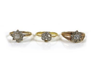 An 18ct gold diamond daisy ring, missing two stones, each st...