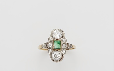 An Art Déco 14 kt gold platinum diamond and emerald ring.