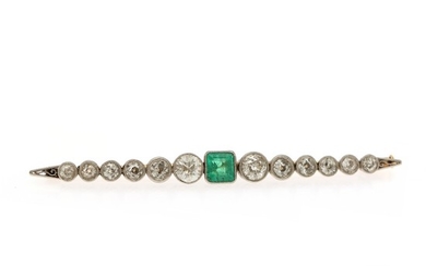 An Art Deco brooch set with an emerald flanked by numerous old-cut diamonds, totalling app. 2.50 ct., mounted in platinum and 18k gold. L. 7 cm. Circa 1920.