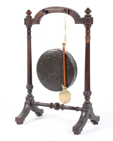 An Edwardian oak framed dinner gong