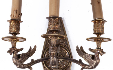 An Empire style three-light bronze wall-sconce with winged creatures...