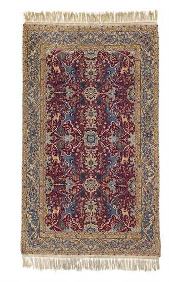 An Isfahan rug, Persia. Decorative all over design of palmettes, rosettes, entwined branches, flowers, foliage and animal motifs. Mid-20th century. 253×148.