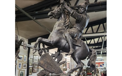 An antique metal sculpture of a fighting warrior on horse b...
