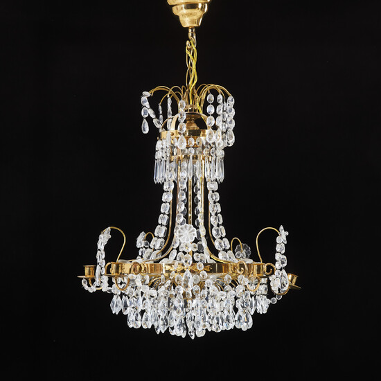 Chandelier, brass frame, second half of the 20th century, Empire style, for five candles, hung with differently cut prisms, electrified inside.