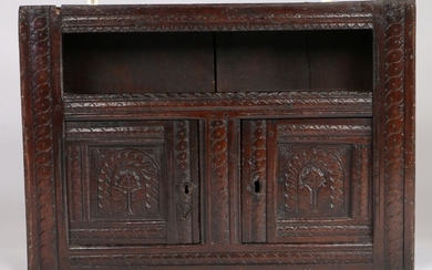 Charles I oak mural glass case livery cupboard, West Country, circa 1640, the rectangular plank