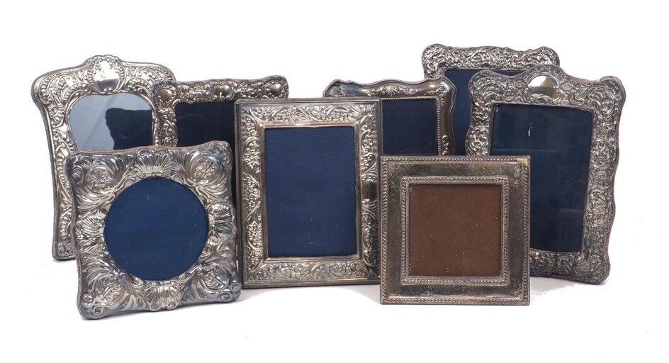Eight silver mounted photo frames including a shaped square example, Sheffield, c.1992, Carr's of Sheffield; a rectangular floral patterned example by the same maker, c.1994, and a shaped rectangular example with shell and bead border, Sheffield...