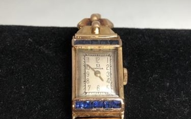OMEGA. Lady's watch in yellow gold and small...