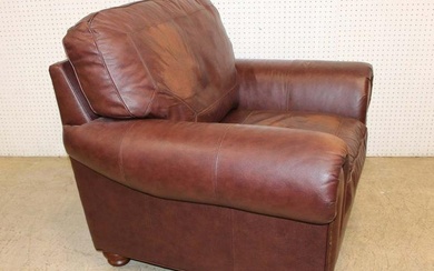 Oversize leather club chair with arm tacking in the chocolate brown and nice patina on cushion