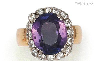 Platinum and yellow gold ring set with an oval amethyst in a ring of old cut diamonds. Tour of doigt : 52. P. Brut : 7.5 g.