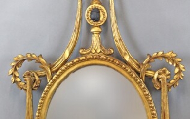 Specchiera di linea ovale in legno intagliato e dorato, altezza cm.120x66, XX secolo