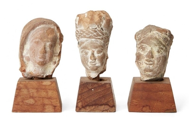 Three small sandstone carved heads, Gupta period, India, 3rd-4th century AD, on wood plinths, each approx. 3cm. high without plinth (3) Provenance: The private collection of Donald and Valerie Coombs. The Coombs lived in Mumbai (Bombay) from 1967...