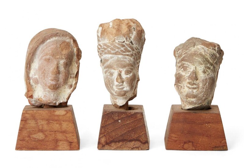 Three small sandstone carved heads, Gupta period, India, 3rd-4th century AD, on wood plinths, each approx. 3cm. high without plinth (3) Provenance: The private collection of Donald and Valerie Coombs. The Coombs lived in Mumbai (Bombay) from 1967...