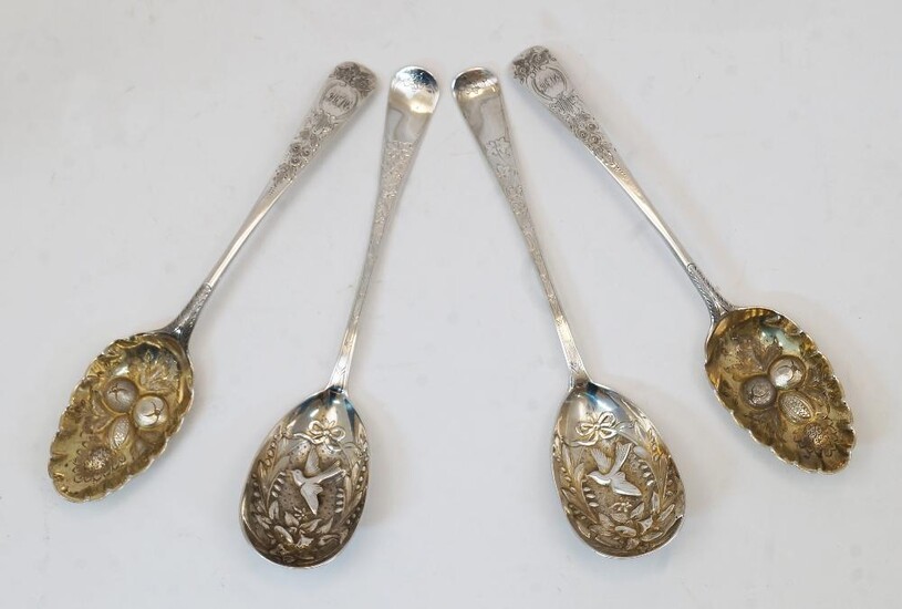 Two late 18th century later decorated silver spoons, one George Smith III, the other with indistinct marks, the gilt bowls later repousse decorated with berries and foliage, the handles later chased with flowers and foliage and with engraved...