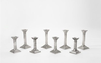 Two sets of English silver Corinthian column candlesticks...