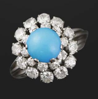 White gold ring with turquoise cabochon and diamonds...