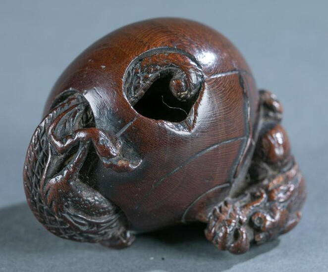 Wood netsuke of dragon in jewel, 19th century.