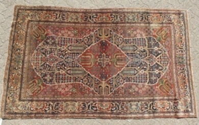 A PERSIAN KASHAN KORK WOOL RUG with a large central
