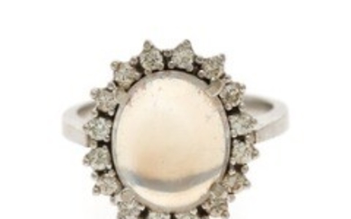 1927/1140 - A moonstone and diamond ring set with a cabochon moonstone encircled by numerous brilliant-cut diamonds, mounted in 18k white gold. Size 48.