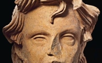 AN ETRUSCAN TERRACOTTA HEAD OF A GIRL, CIRCA LATE 4TH-EARLY 3RD CENTURY B.C.